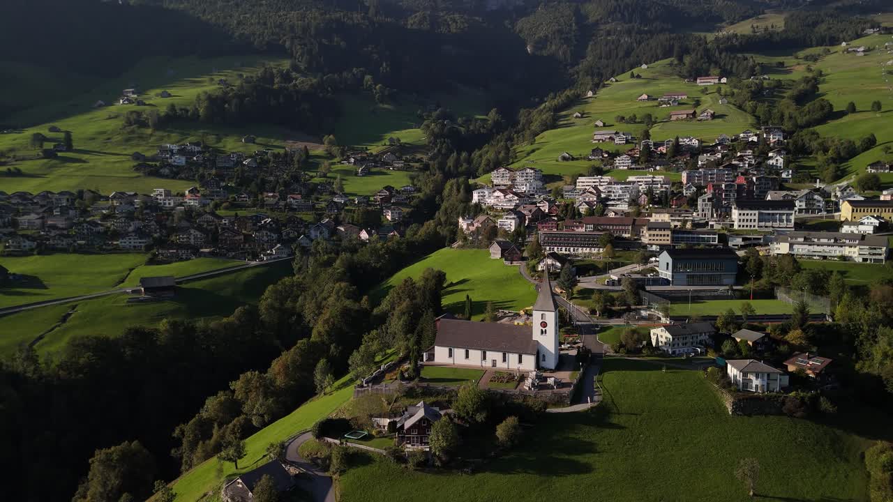 Swiss Switzerland alpine village surrounded by beautiful nature, aerial
