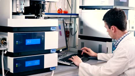 the worker considers holding jar in the lab.