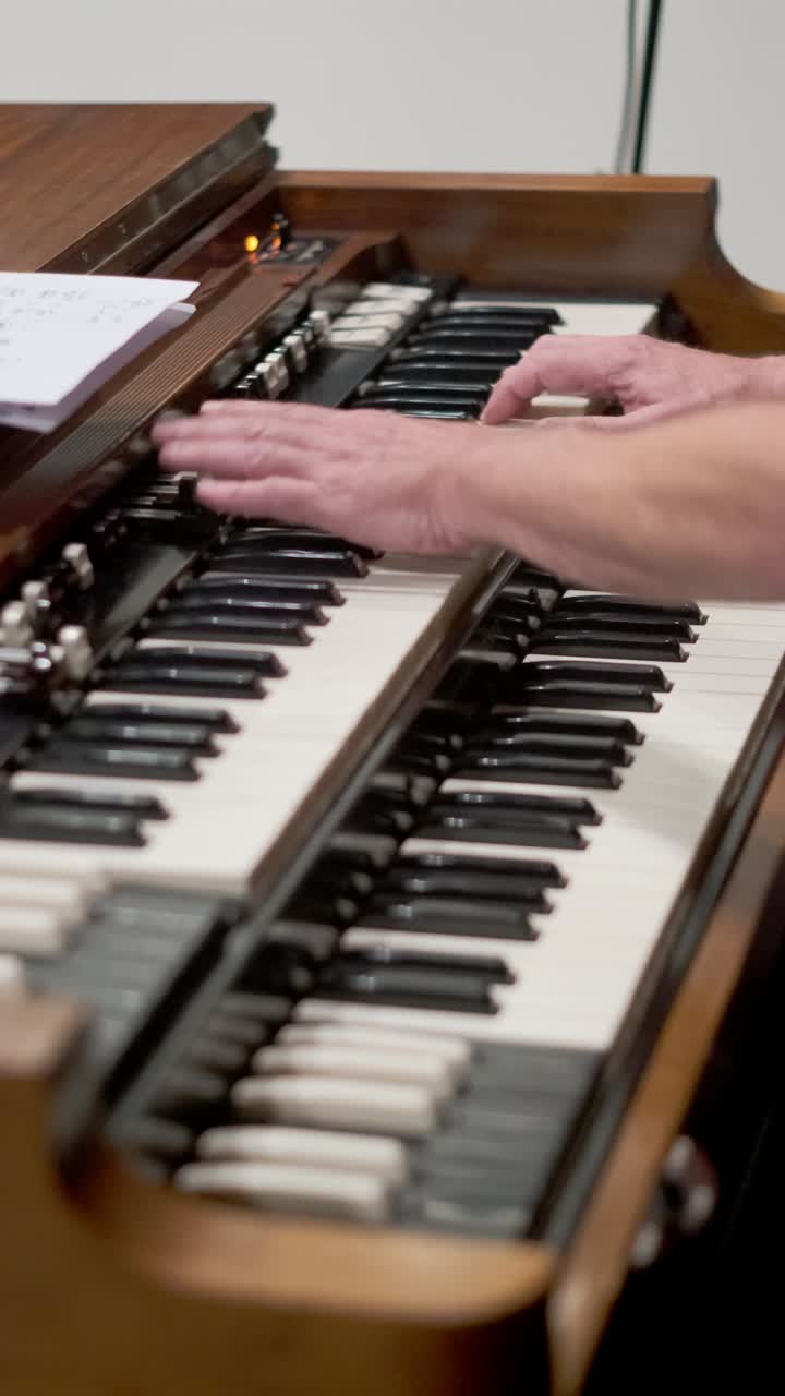 Hands Playing Organ At Studio. closeup, vertical shot