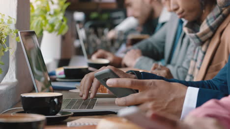 diverse business people hands using laptop computers in busy cafe bustling with activity working online browsing sharing digital email communication