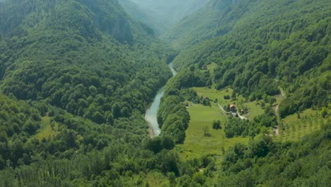 tourists riding a zip line over river of tara in montenegro