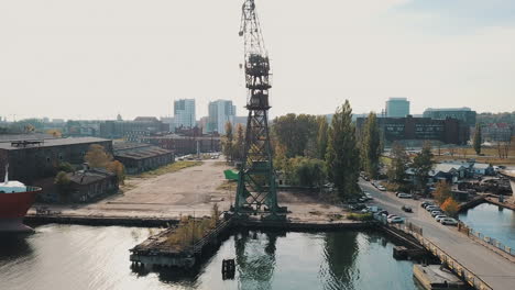 Drone-flying-around-big-crane-in-the-shipyard-docks