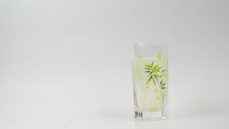 hand adding supplement to a glass of water