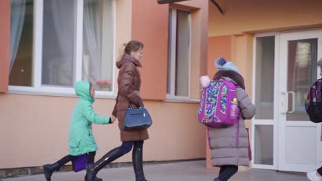 children and parents entering school