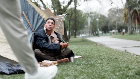 homeless man begging for donation in park