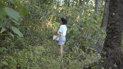 pretty girl hiker exploring the green forest