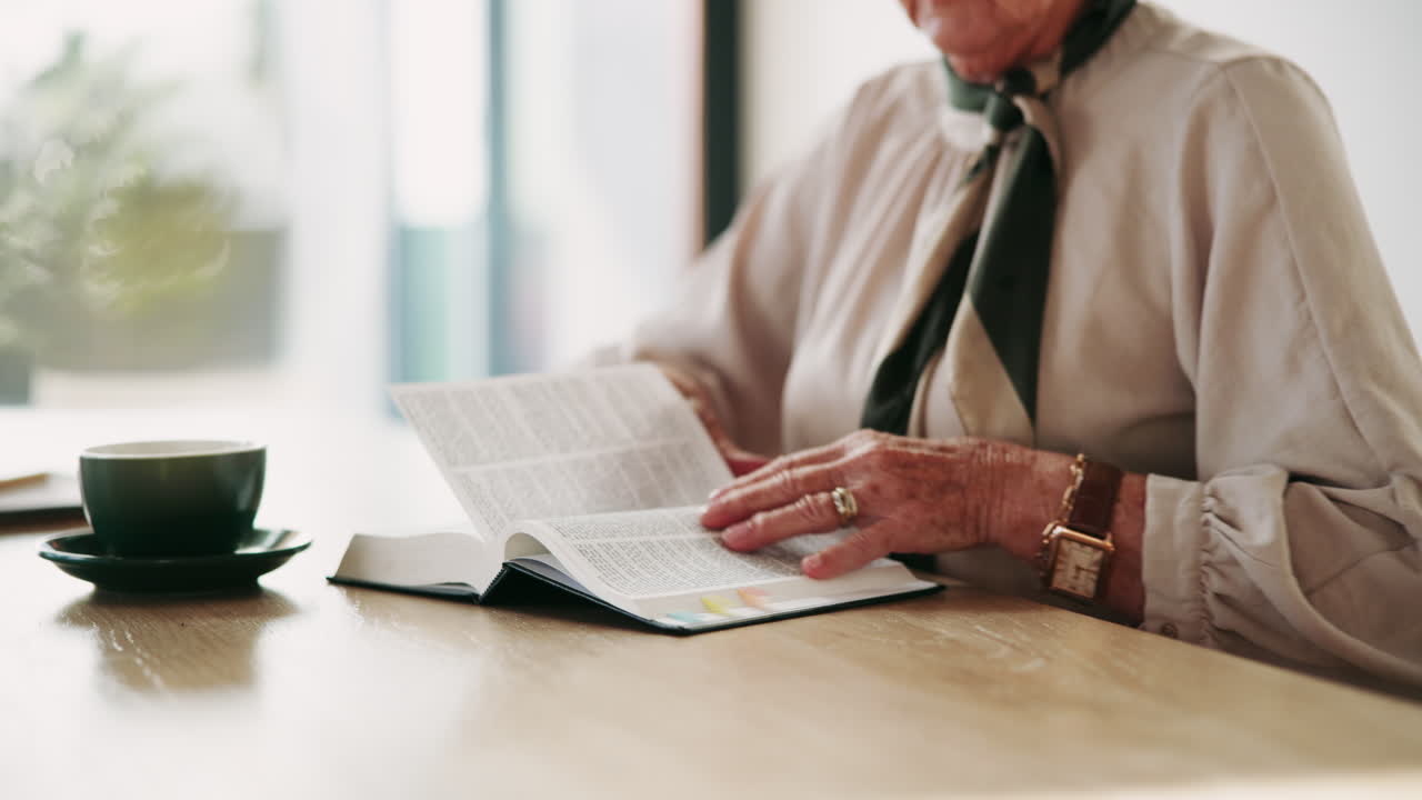 Senior Woman Reading a Book with Coffee