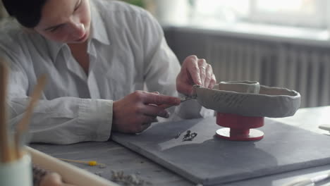 woman crafting pottery on a wheel