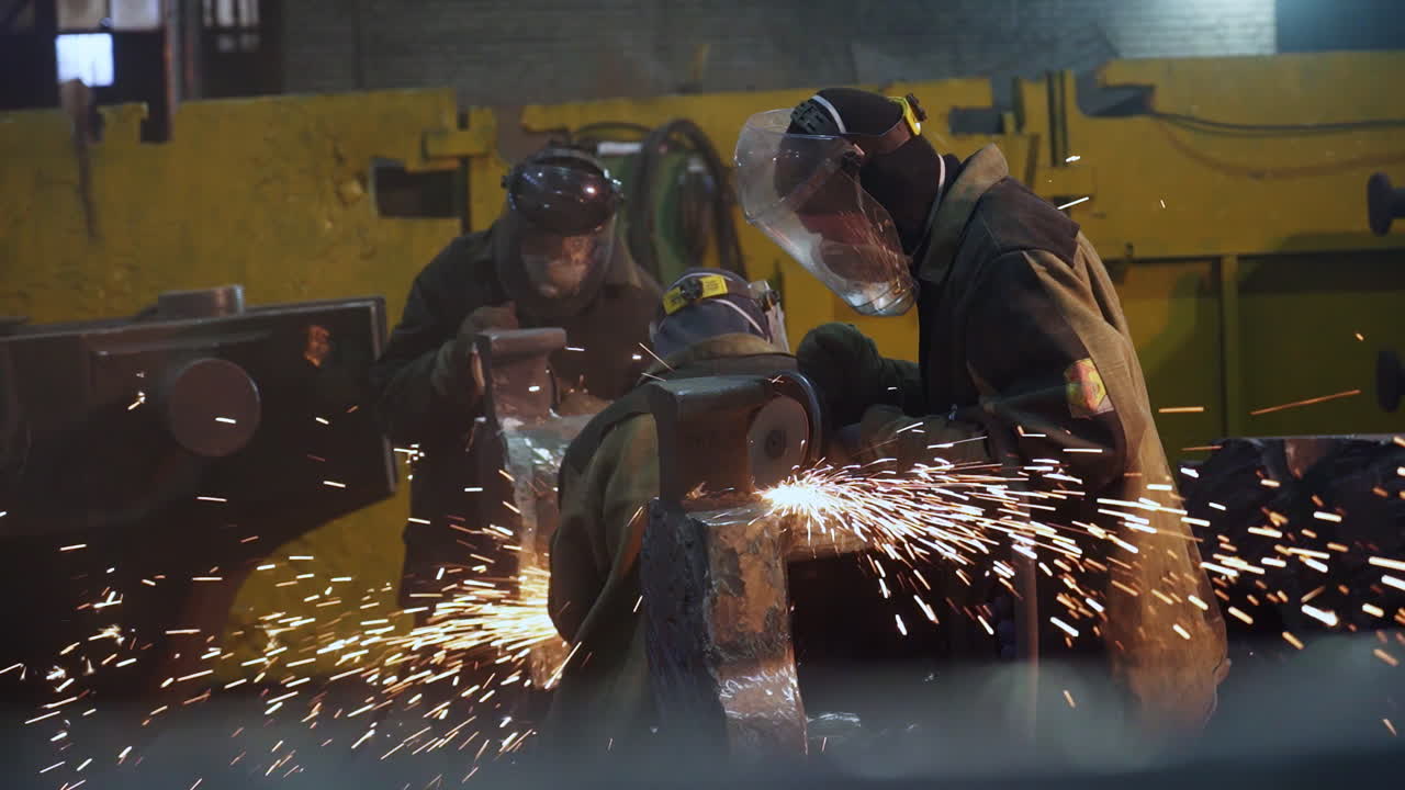 Metal Workers Grinding Metal