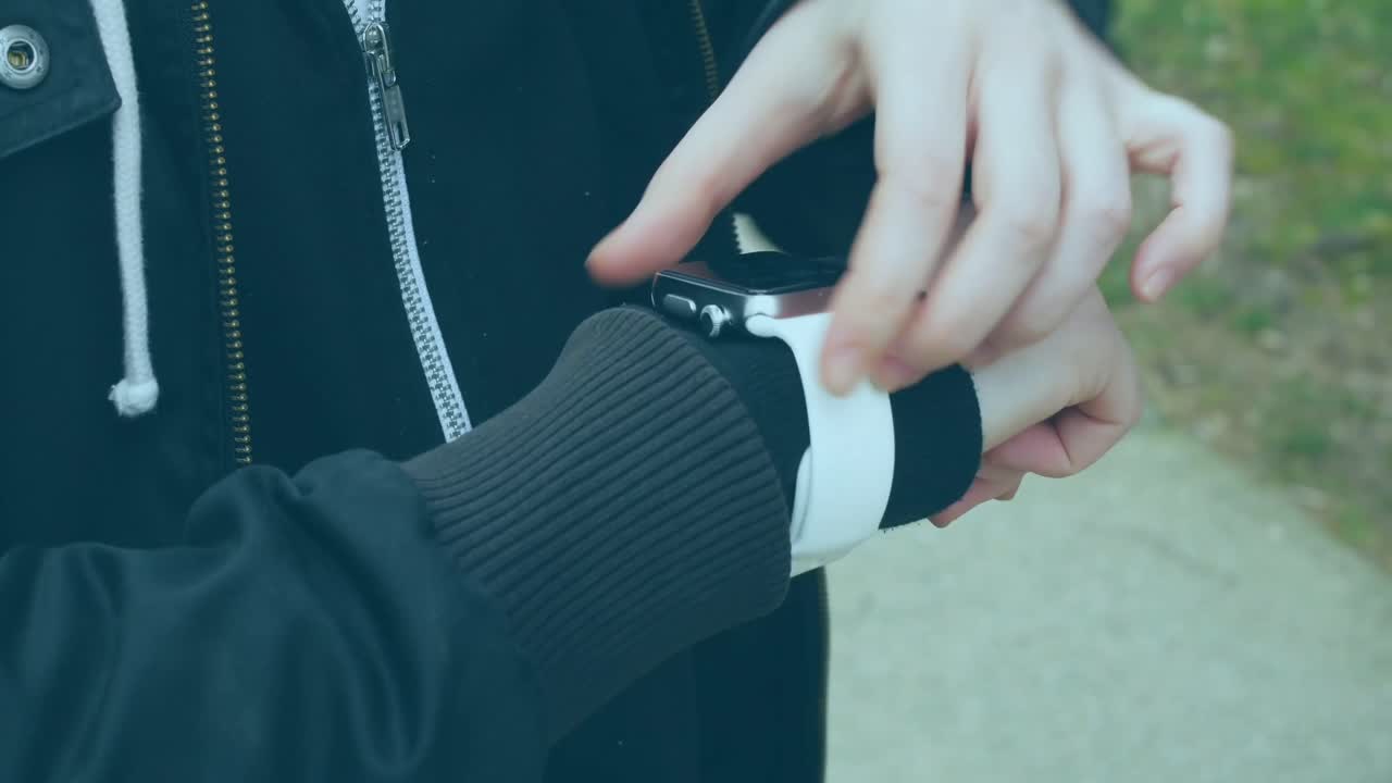 Animation of data processing on screens over caucasian man checking smartwatch