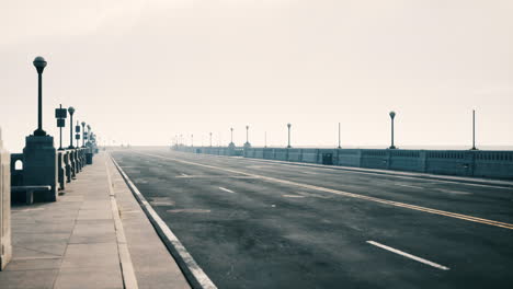 empty bridge road in foggy morning