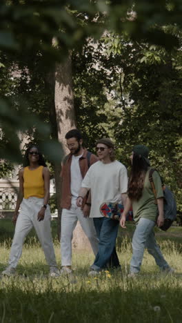 a group of friends walking through a park with a skateboard