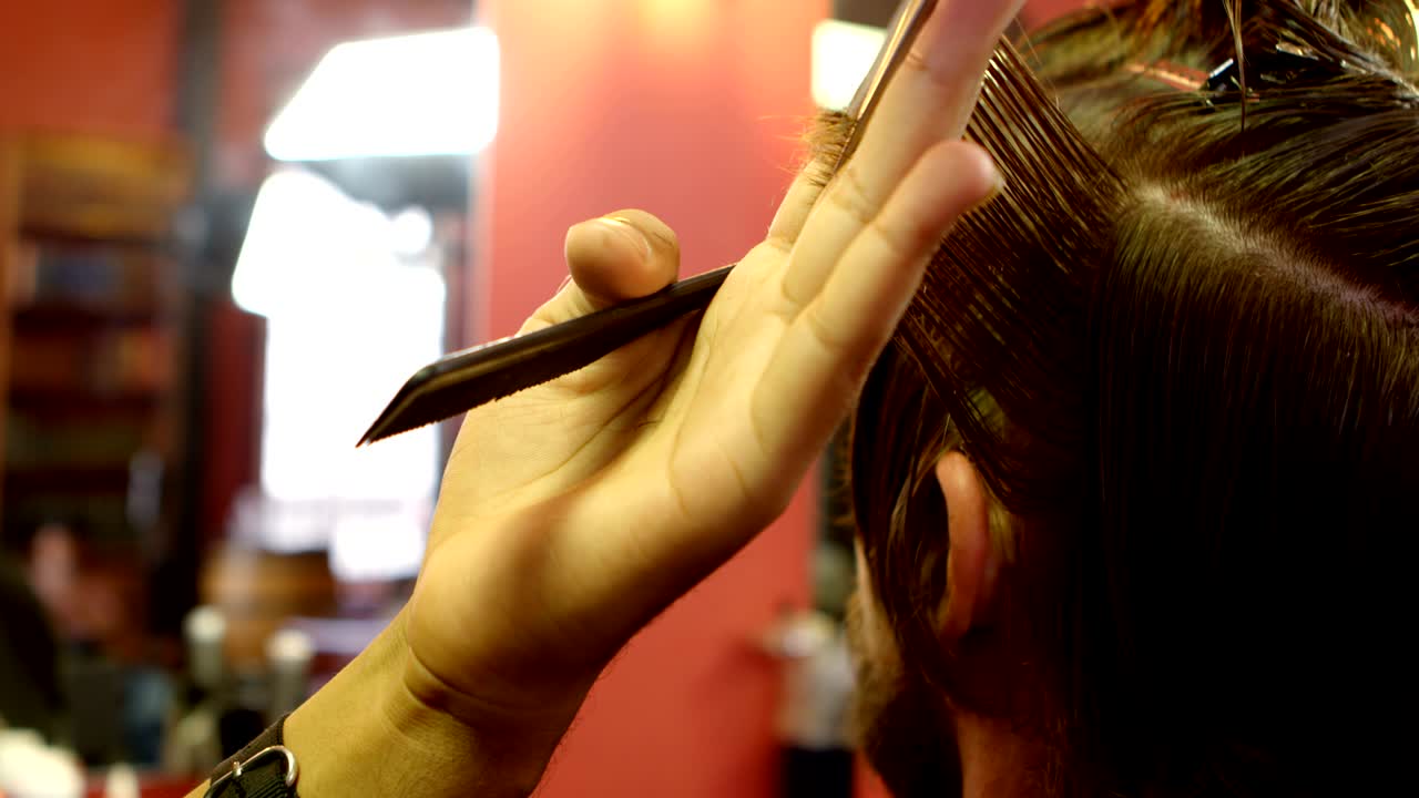 Man getting his hair cut by hairdresser 4k