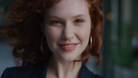 close-up-portrait-young-beautiful-business-woman-turns-head-smiling-happy-wind-blowing-hair-cute-red-head-female-feminine-beauty-slow-motion