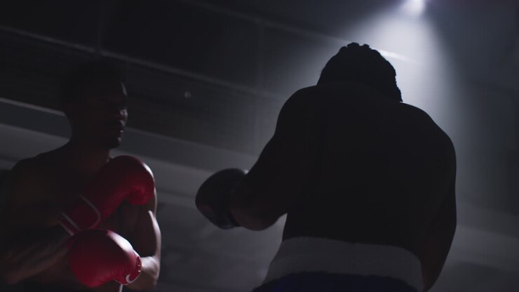 Close Up Shot Of Two Male Boxers Wearing Gloves In Boxing Ring Fighting In Boxing Match With Low Key Lighting 5