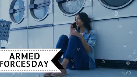 Animation-of-armed-forcesday-text-over-biracial-woman-with-washing-machine