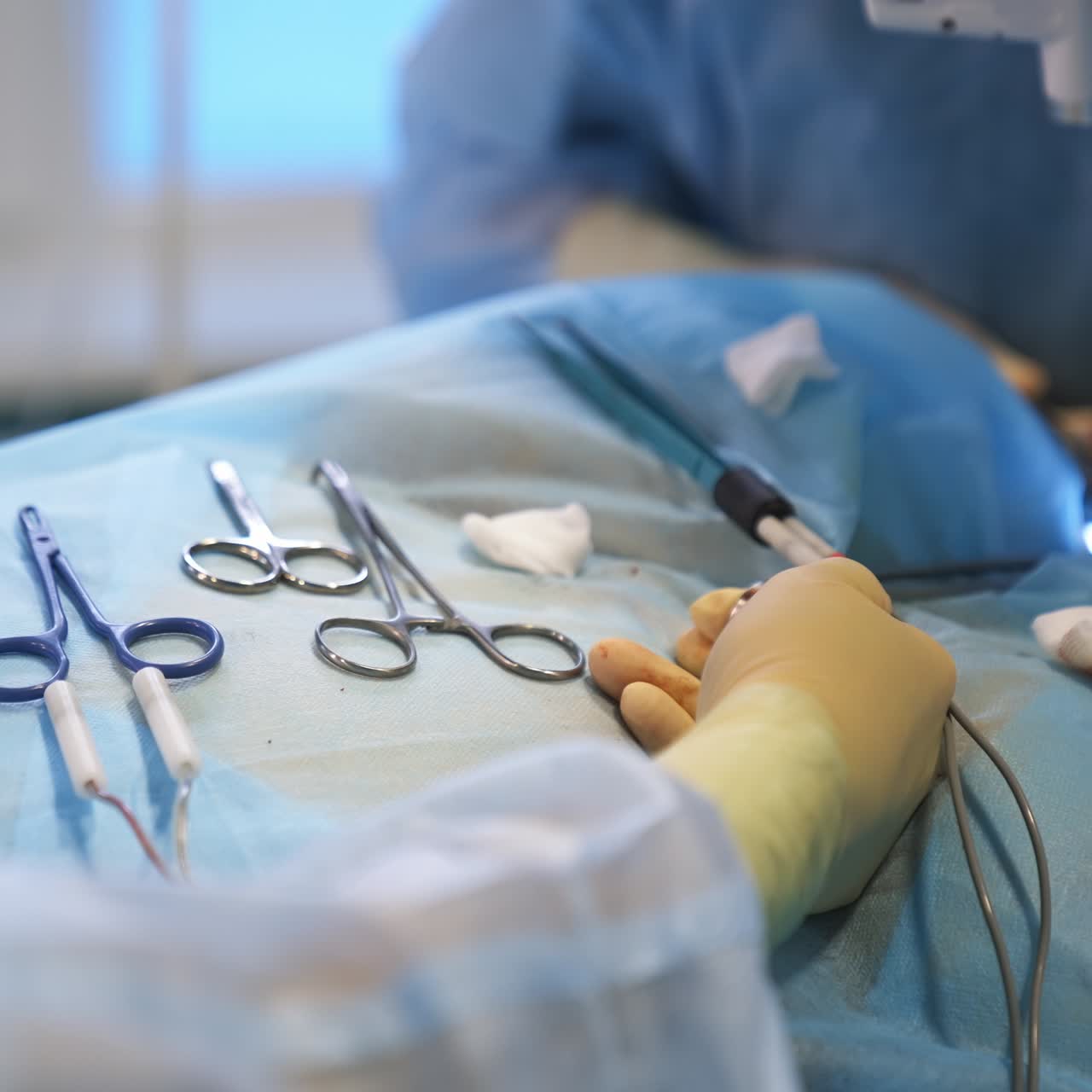Medical nurse's hands in gloves arranges instruments for the operation. Surgeon's assistant holds a tool helping doctors