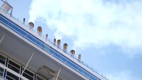 close-up of cruise ship exhaust pipes against a blue sky