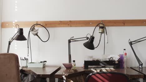 general view of empty workshop with desks and lamps in jewellery studio in slow motion