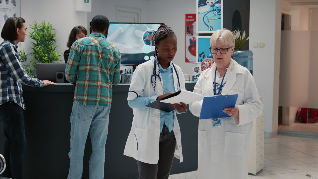 Doctors discussing patient information at hospital reception