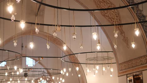 ornate ceiling with hanging lights in a mosque