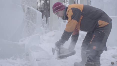 ice sculptor carving with chainsaw