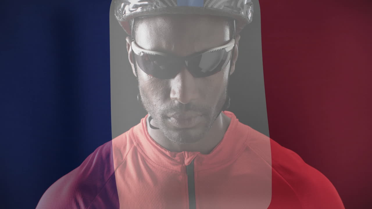 Animation of flag of france over caucasian male cyclist