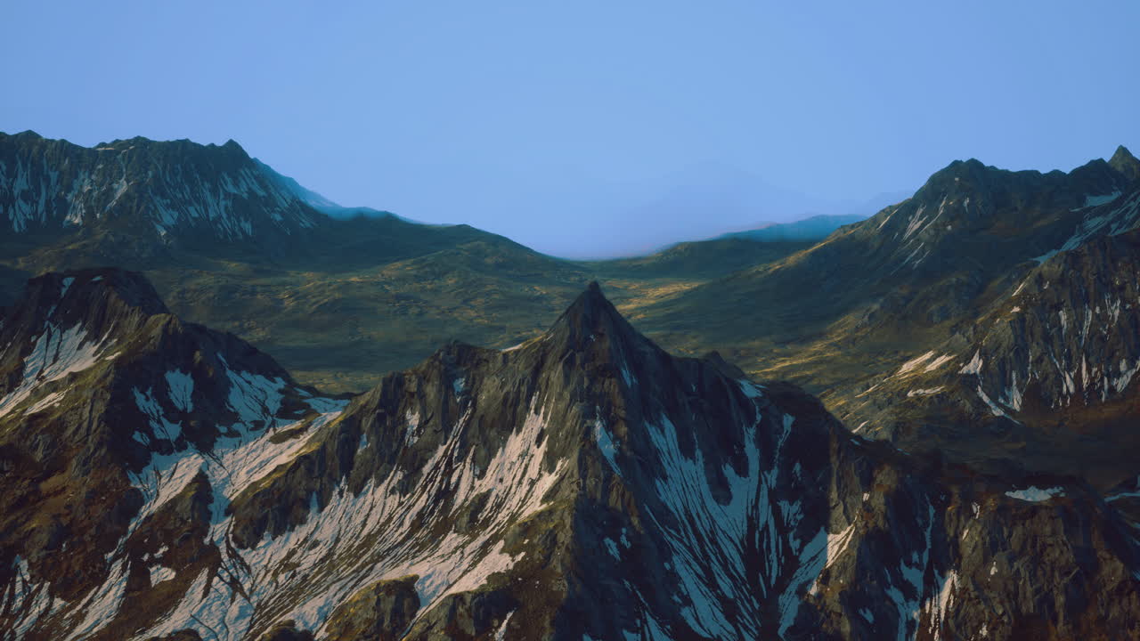 Mountains rise majestically under a clear sky in a remote landscape