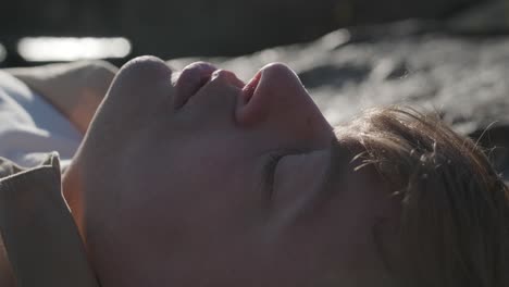 young man resting outdoors, finding peace, thoughtful and happy.
young man lying on the ground outdoors looking at the sky, dreaming, hoping, finding peace.