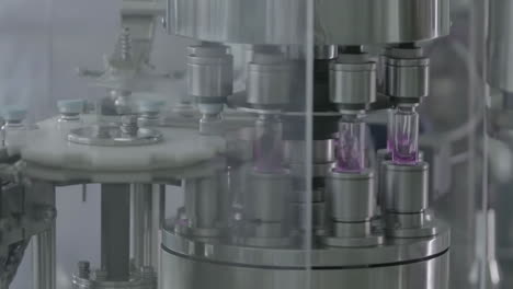 pharmaceutical production line sterile conditions in cleanroom filling vials with medication at manufacturing facility