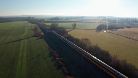 aerial shot of two express trains passing by in czech countryside railways