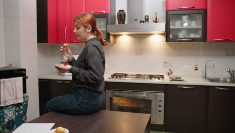 sitting on the table a woman eats delicious cookies