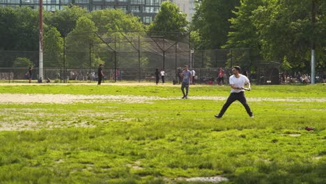 greenpoint mccaren park people playing frisbee and baseball on a warm day