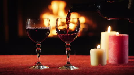 the waiter pours wine into the glasses in the background a fire burns in the fireplace