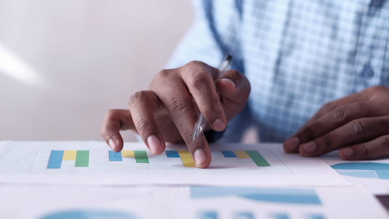 Person reviewing bar charts and pie charts