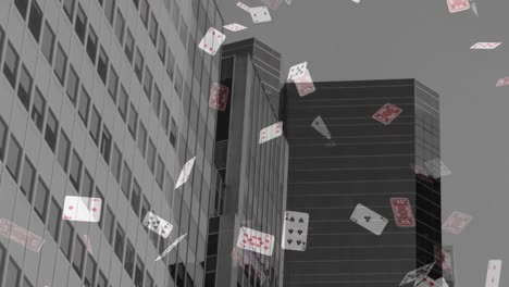 animation of playing cards falling over cityscape