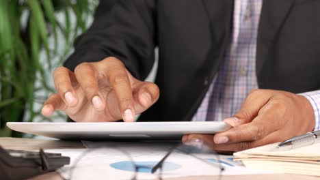 businessman using digital tablet on office desk