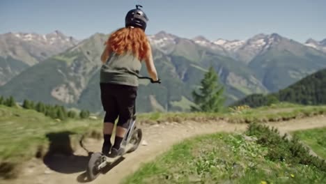 woman riding a scooter on a mountain trail
