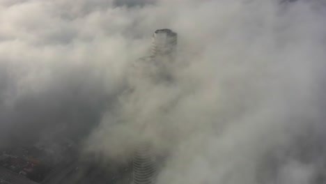 skyscraper pierced by clouds