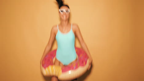 woman having fun with donut float