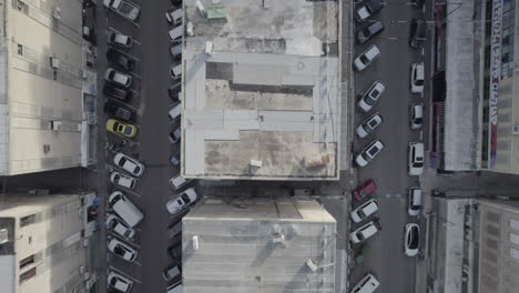 aerial view of city buildings and parking lot