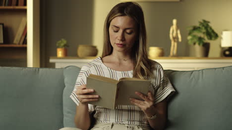Woman Reading a Book on Couch