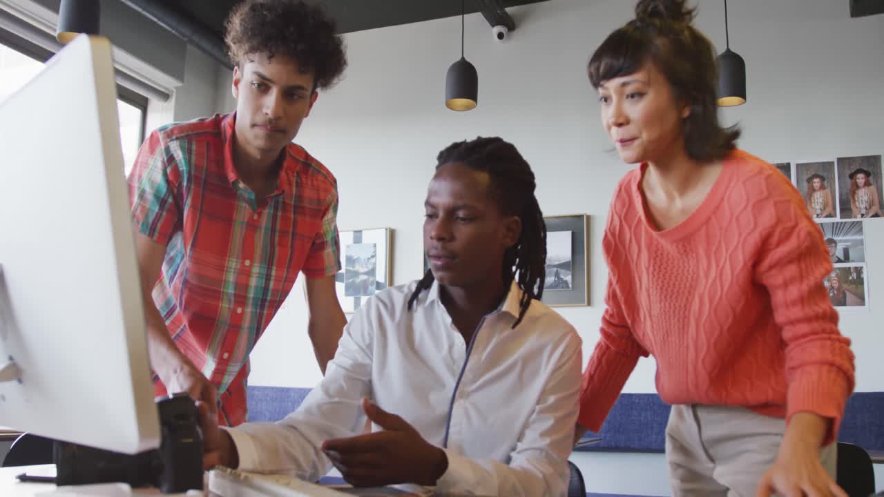 Happy diverse business people discussing work during meeting at office