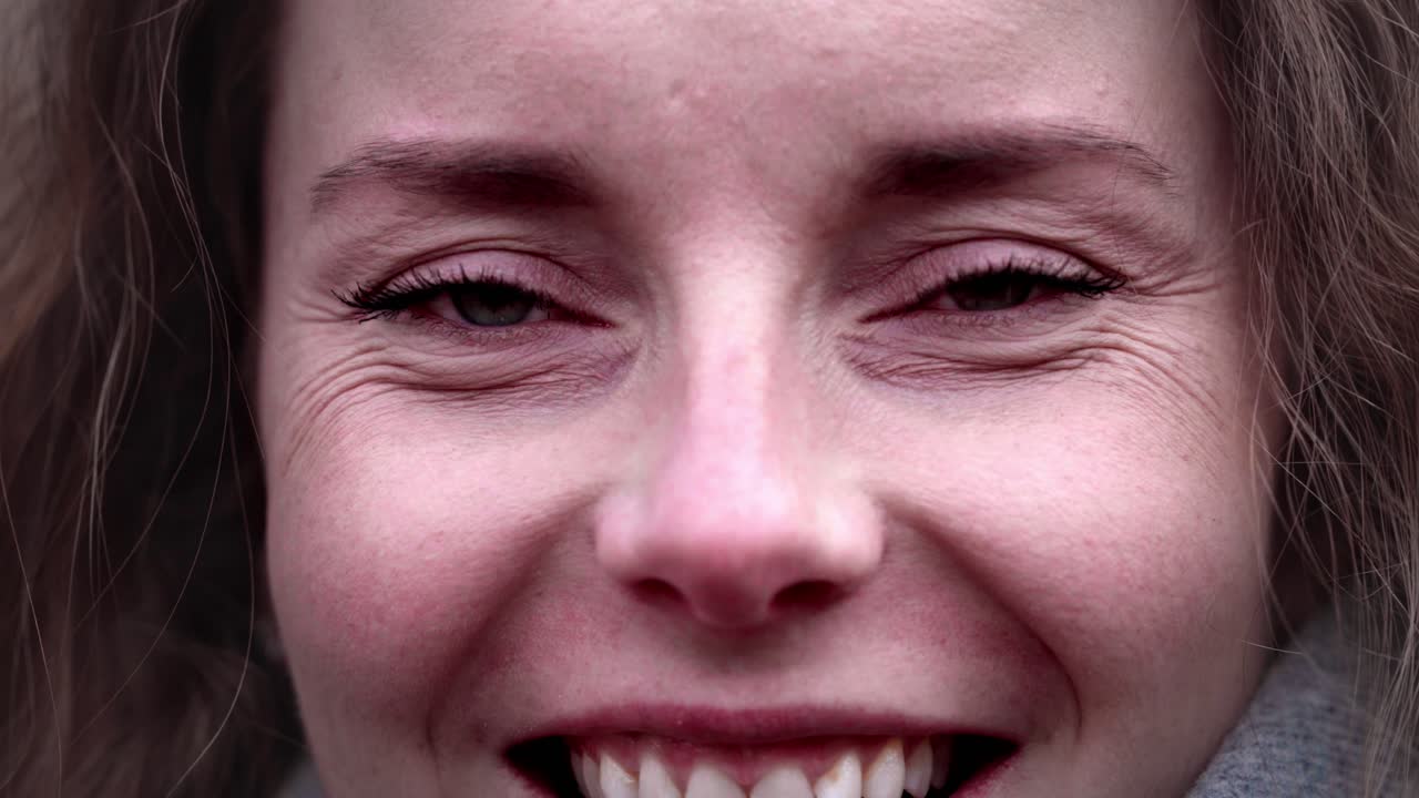 Close Up of curly women face with different eye colors, heterochromia