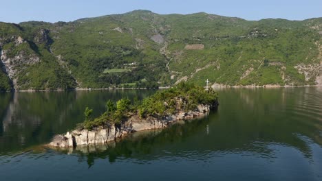 rocky tiny island on koman lake, beautiful ferry journey on albanian mountains