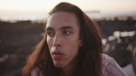 happy biracial man looking away at beach, slow motion