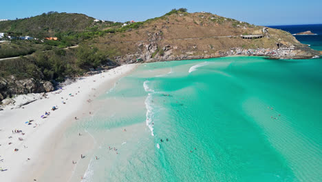 epic destination in brazil, arraial de cabo beach crowded with people - aerial shot