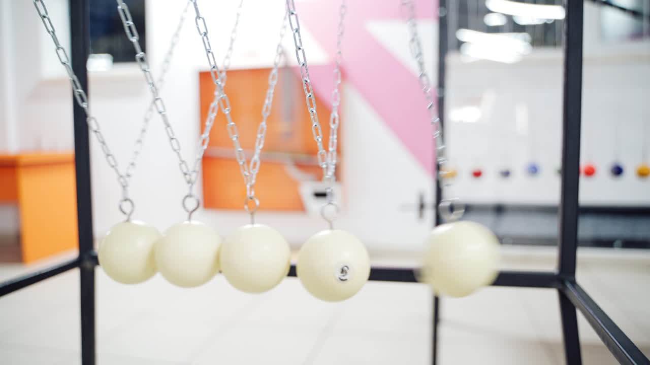 Newton's cradle showing laws of physics in motion. Museum of Science and newton pendulum