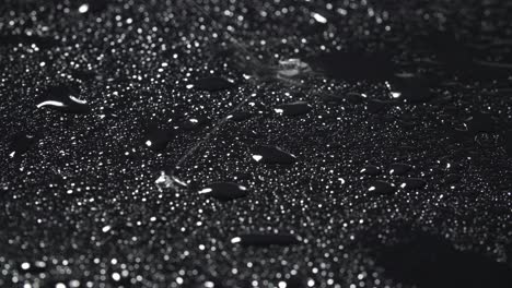 close-up video of rainy drops on black background