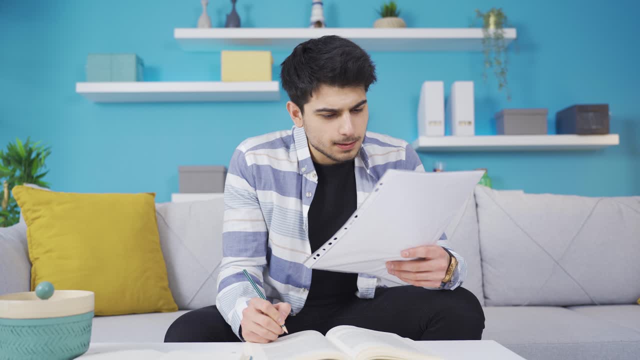 Young man studying at home.